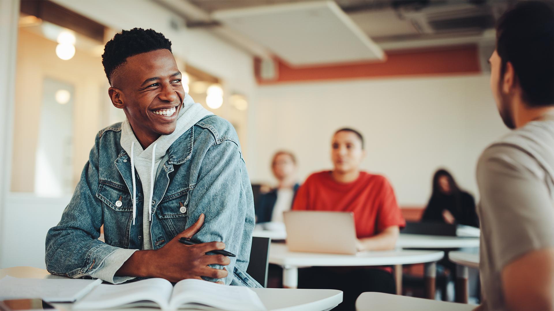 NYLFES header image. Male students in class.
