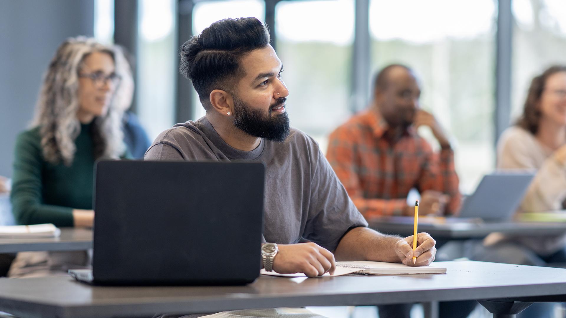 Man writing in class