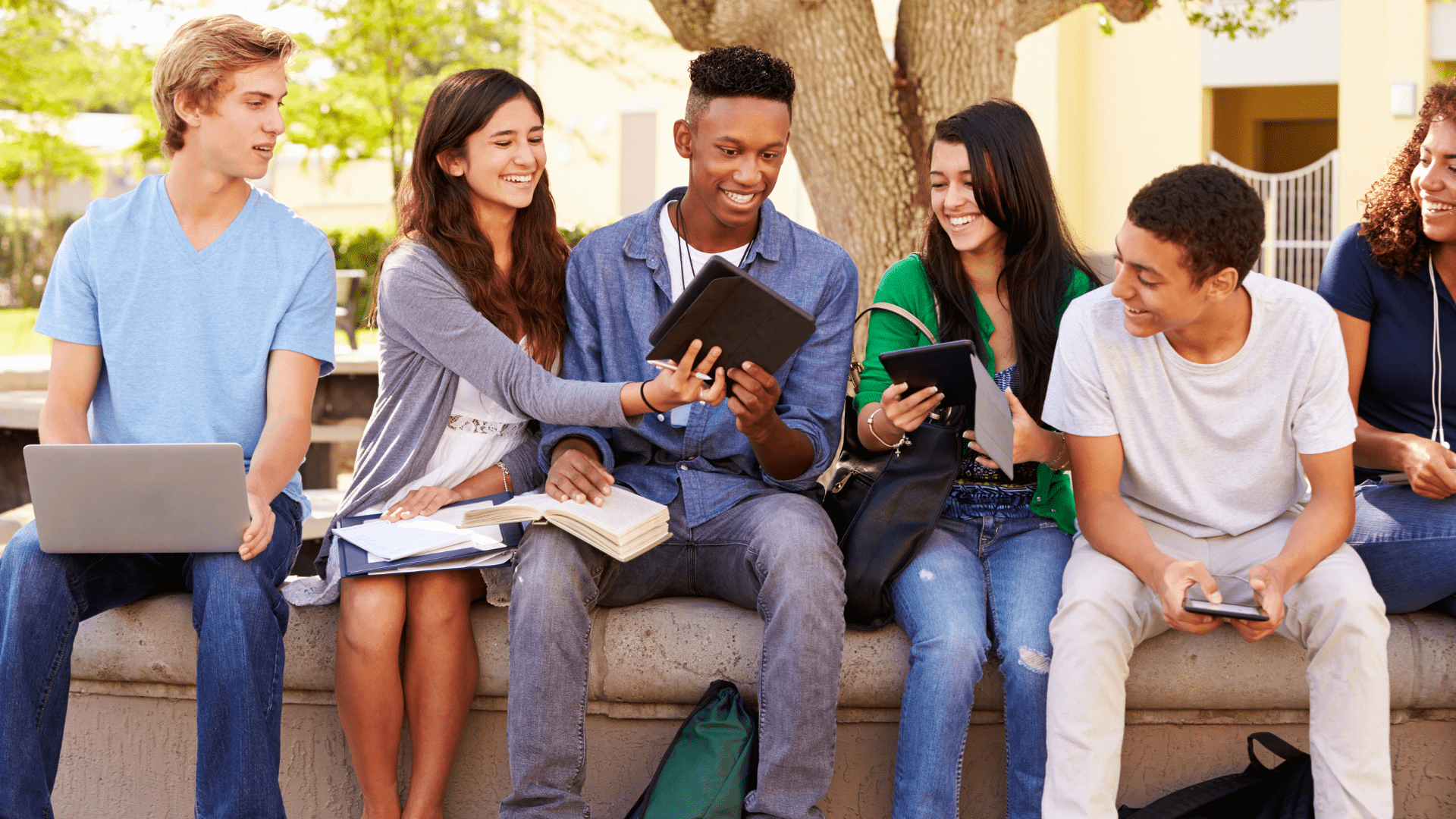 Five students outdoors on a college campus